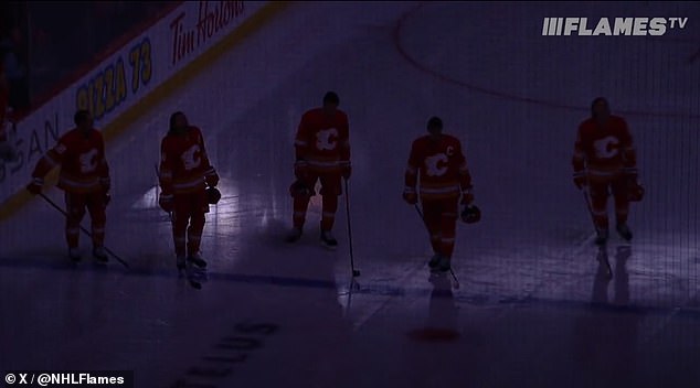 Flames players tapped their sticks on the ice in a sign of applause for Snow before they faced off