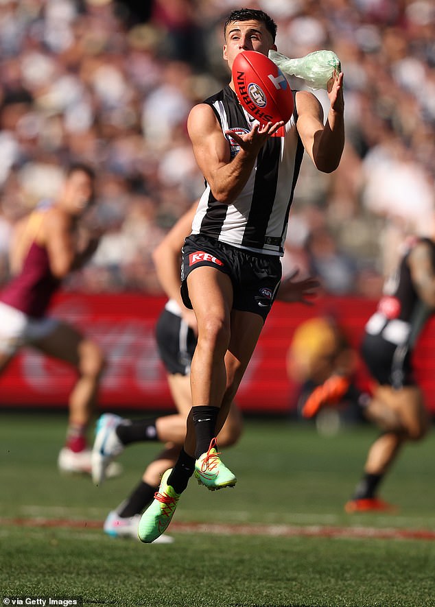 In bizarre scenes, the Magpies' young gun also caught a plastic bag (pictured) during the see-saw match against the Brisbane Lions at the MCG