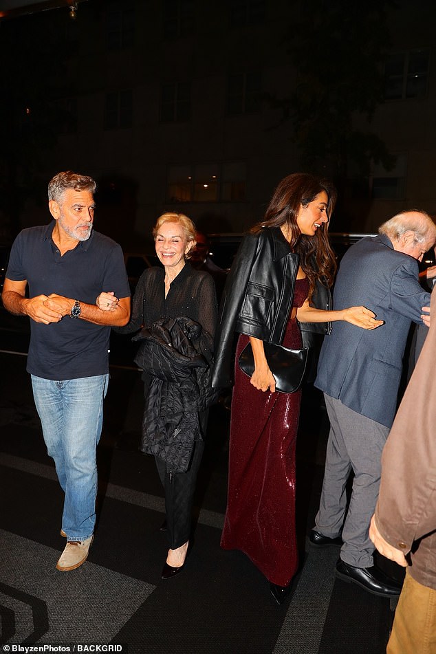 George locked arms with his mother while Amal talked to his father