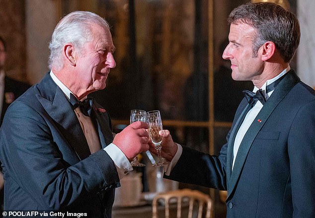 The monarch's swollen hands were on full display last week as he toasted French President Emmanuel Macron at a state banquet at the Palace of Versailles.