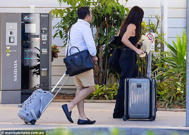 The couple had their hands full with all their luggage as they headed to their flight