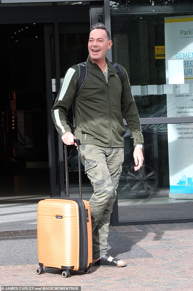 Smiling: Craig Revel Horwood looked comfortable and casual in camouflage trousers and a khaki zip-up jacket