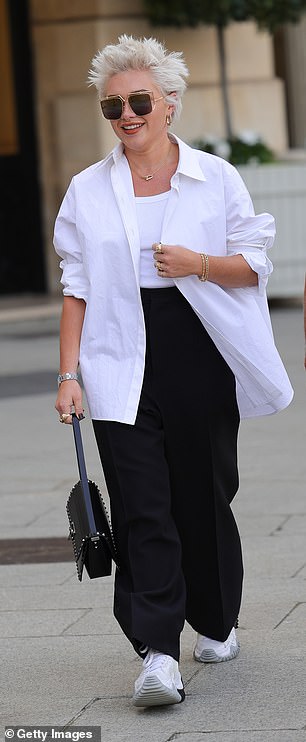 Practical: Florence wore a simple open white shirt that she paired with a white vest top and black wide-leg pants