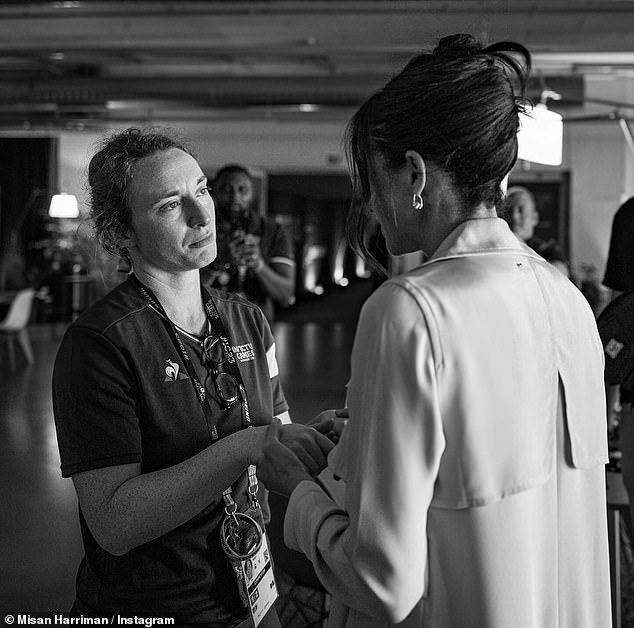 A final photo shared by Mr Harriman, who lives in London, shows the Duchess wearing a chic updo as she holds the hands of a competitor