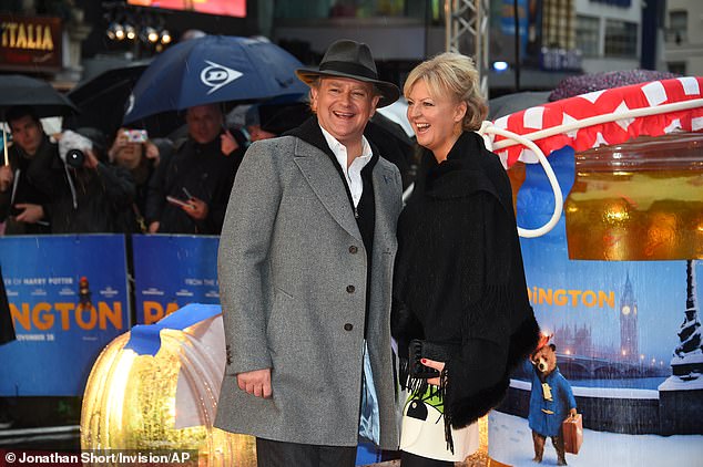 Actor Hugh Bonneville and his wife Lulu Williams pose for photographers as they arrive at the world premiere of the film Paddington in London, Sunday, November 23, 2014