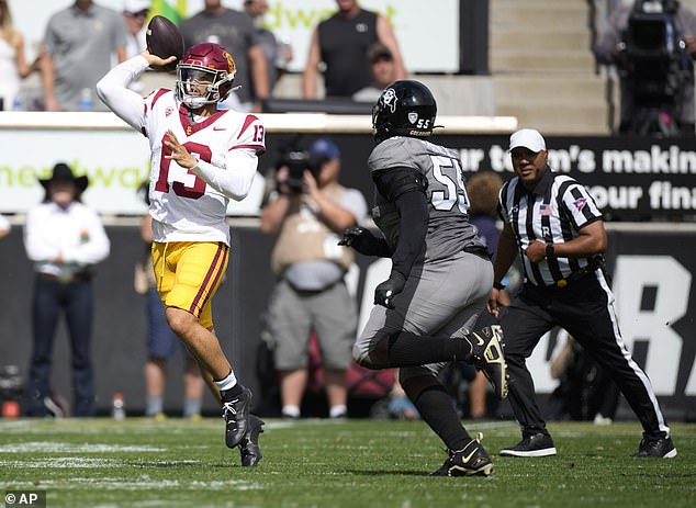 Williams, left, throws a pass under pressure from Colorado defensive lineman Leonard Payne