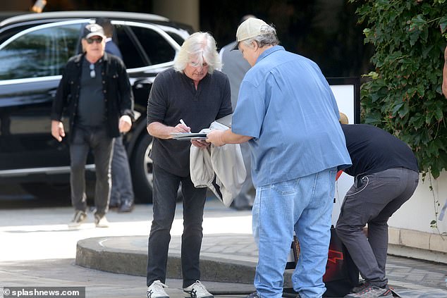 Cliff Williams.  73. and Brian Johnson, 75, (both pictured) delighted fans Friday as they left their room at the Four Seasons Hotel in Beverly Hills to sign autographs