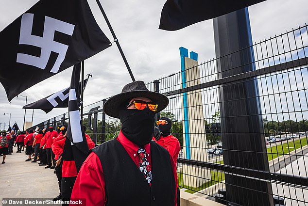 The slogan “ban the ADL” was vigorously promoted by white nationalists on X, and was chanted by members of the neo-Nazi groups “Blood Tribe” and “Goyim Defense League” as they marched Saturday (above) in Altamonte Springs, Florida waving swastika flags