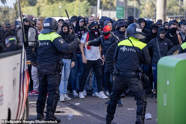 Dutch police were seen using tear gas to disperse crowds gathered outside the stadium after the match was suspended