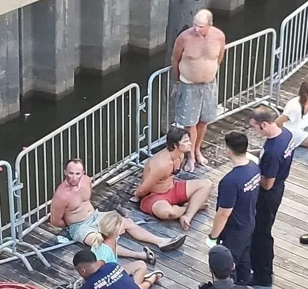 The four people charged so far are in handcuffs on the dock