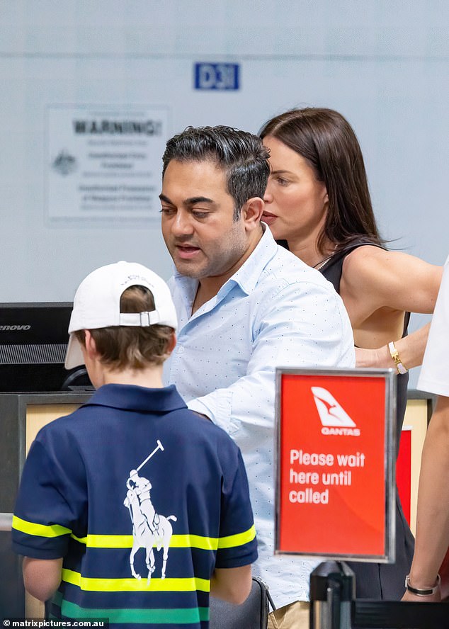 The glamorous cosmetics nurse, 45, and Sachin, a plastic surgeon in New York, had a tense conversation as they checked in for their flight with Pike's two sons.