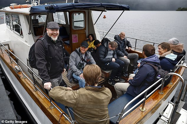 Organizer Alan McKenna (left) joins Nessie hunters aboard a boat on Loch Ness for what was described as the largest search for the Loch Ness Monster since the early 1970s