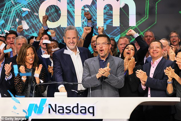 Arm race: Staff led by Rene Haas (white shirt) at the listing.  The chip designer's shares soared on its debut, valuing the British company at more than £50 billion