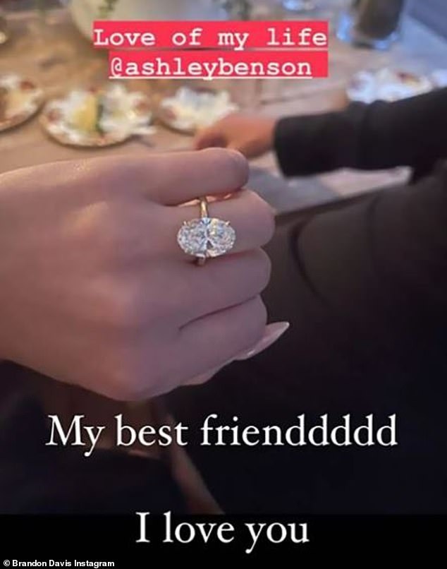 Putting on a ring: The artist started seeing Davis later, and she revealed they got engaged in July, when she posted a photo of her engagement ring to her Instagram