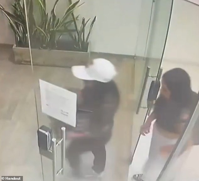 Two women are seen leaving a building in Cali, Colombia, after drugging and robbing a male stranger from Asia, whom one of them met through an online dating app.  The women fled with a luggage bag, a box and the victim's debit card