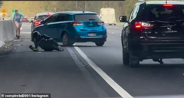 Passing motorists stopped to assist the motorcyclist after he sped across four lanes and crashed into a barrier