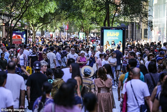 Australia is taking in more than 1,500 people a day as immigration rises and birth rates fall amid an affordability and cost of living crisis (pictured crowds at Sydney's Pitt Street Mall)