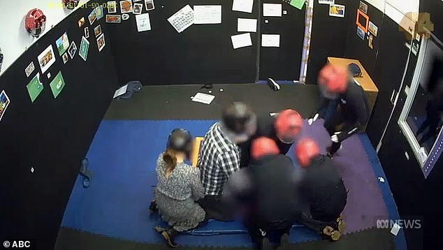 In a disturbing video obtained by ABC's Four Corners programme, a teenager with autism and a severe intellectual disability was shown surrounded by six adults in a padded room (pictured)