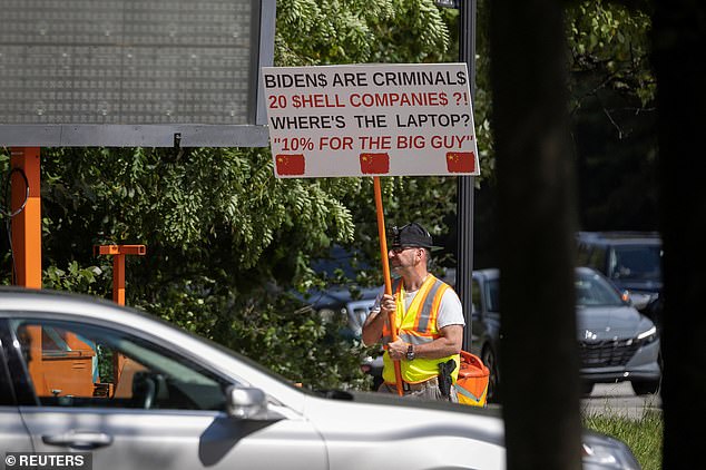 A single man with a gun in his hip holster protested on the street where President Joe Biden's Delaware residence is located