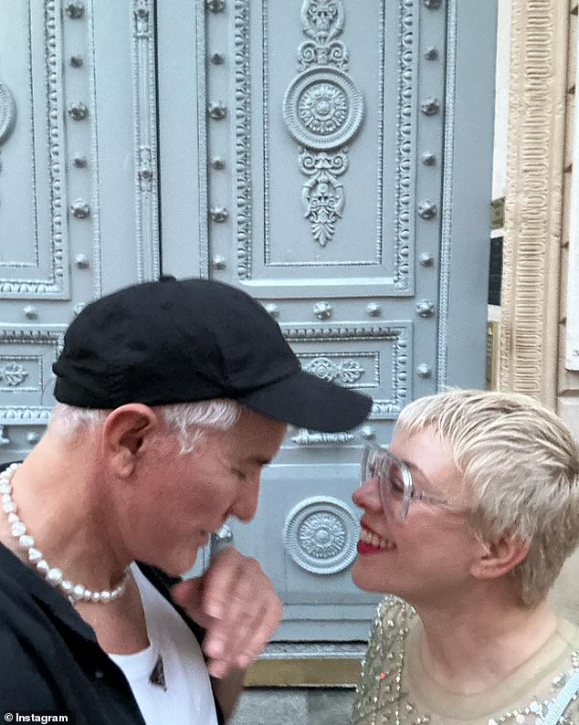 Baz shared on Instagram a tender moment of the couple gazing lovingly into each other's eyes as they stood in front of an ornate blue door