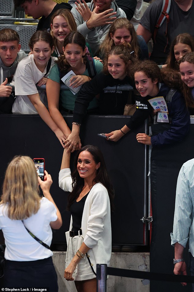 Meghan Markle made a quick dash to take selfies with fans after entering the Merkur Spiel-Arena in Dusseldorf today for the Invictus Games