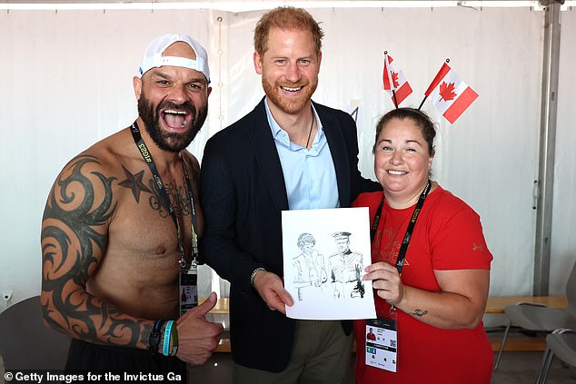 Prince Harry beamed with elation when he was presented with a drawing of himself with his late mother Princess Diana during the Invictus Games in Dusseldorf today