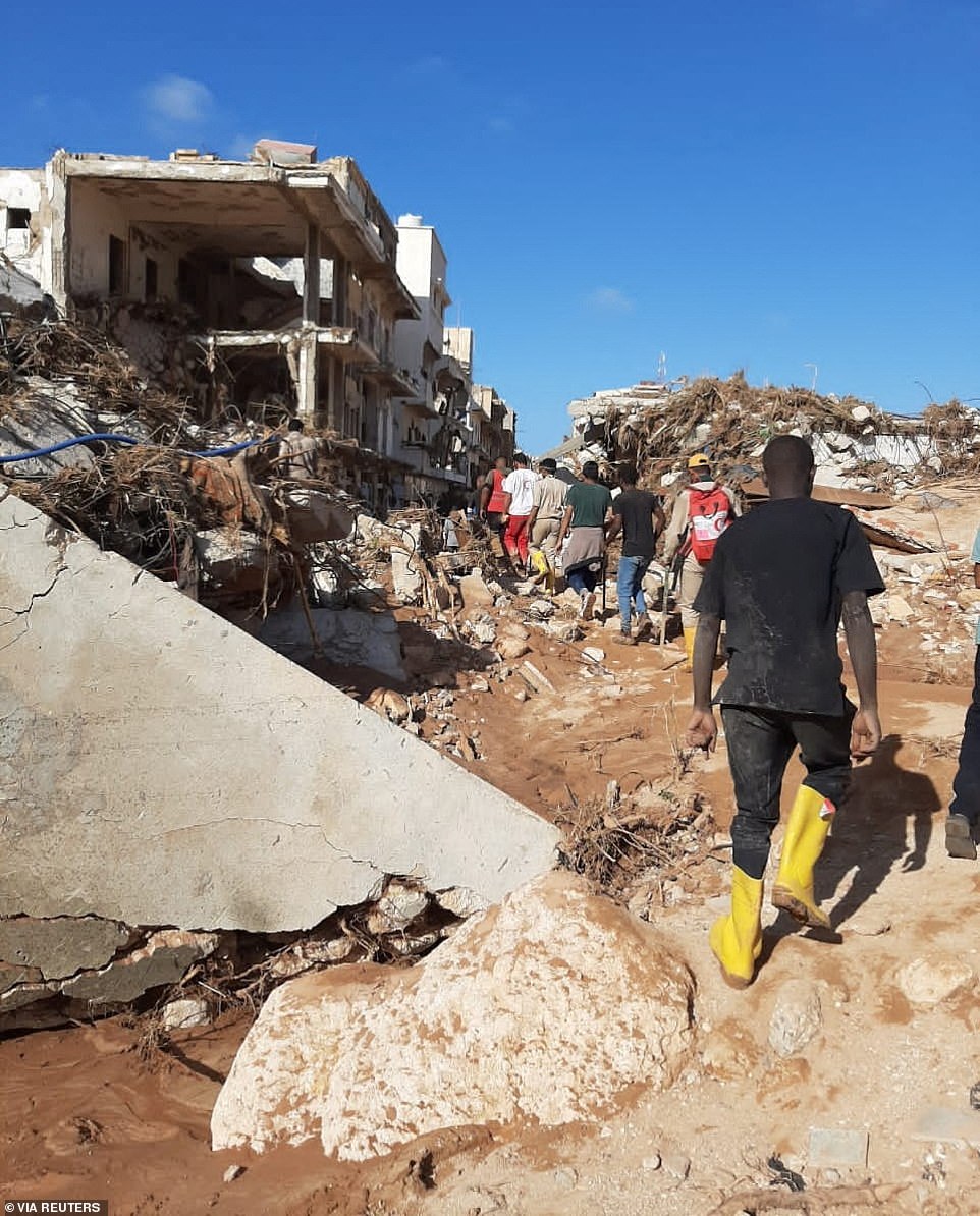 Members of the Libyan Red Crescent Ajdabiya are working in an area affected by flooding.  The flood caused massive destruction, leaving Derna's streets covered in rubble, mud and rubble