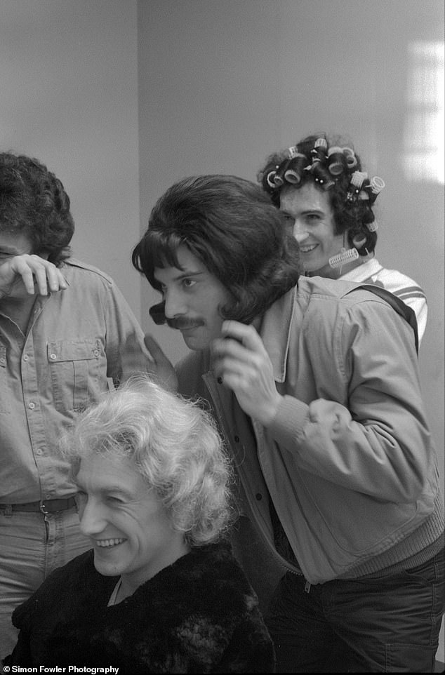 The band laughs backstage as they get ready to shoot the video promo