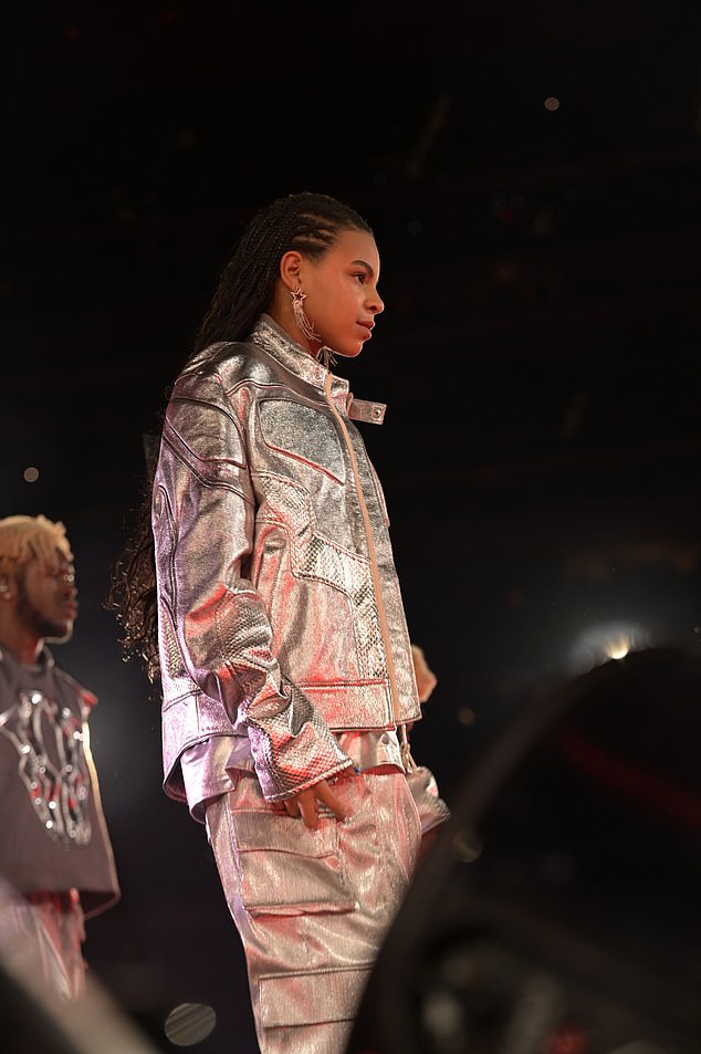 Matching: Earlier this month, daughter Blue Ivy, 11 (pictured) also opted for custom BOSS as she took to the stage with her mother in California, decked out in a matching silver jacket and combat trousers