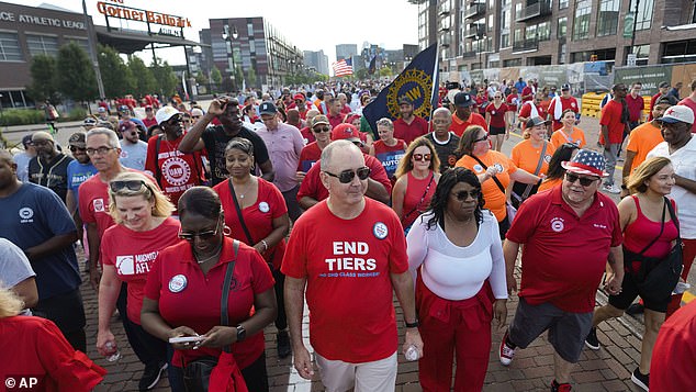 United Auto Workers president Shawn Fain (center) slammed the Detroit Three for not sharing record profits with the workers.  In August, 150,000 car workers threatened to go on strike if a new agreement was not reached by mid-September.  He walked in the Detroit Labor Day parade on Monday