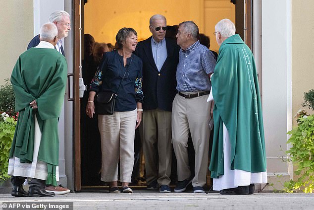 President Joe Biden talks to churchgoers Saturday as he leaves services at St. Joseph on the Brandywine