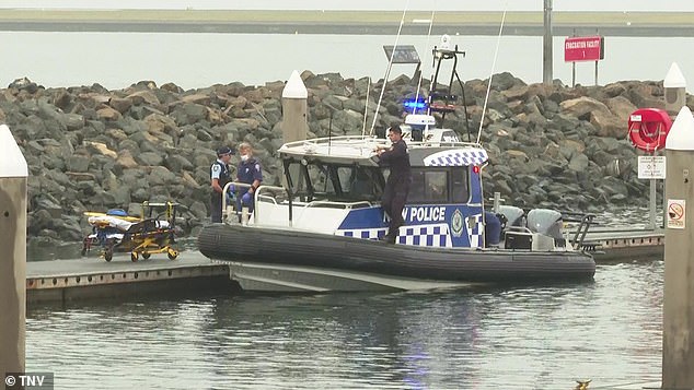 One man died and another was hospitalized after their boat struck a whale and sailed off the coast of Sydney (photo, water police and paramedics on scene)