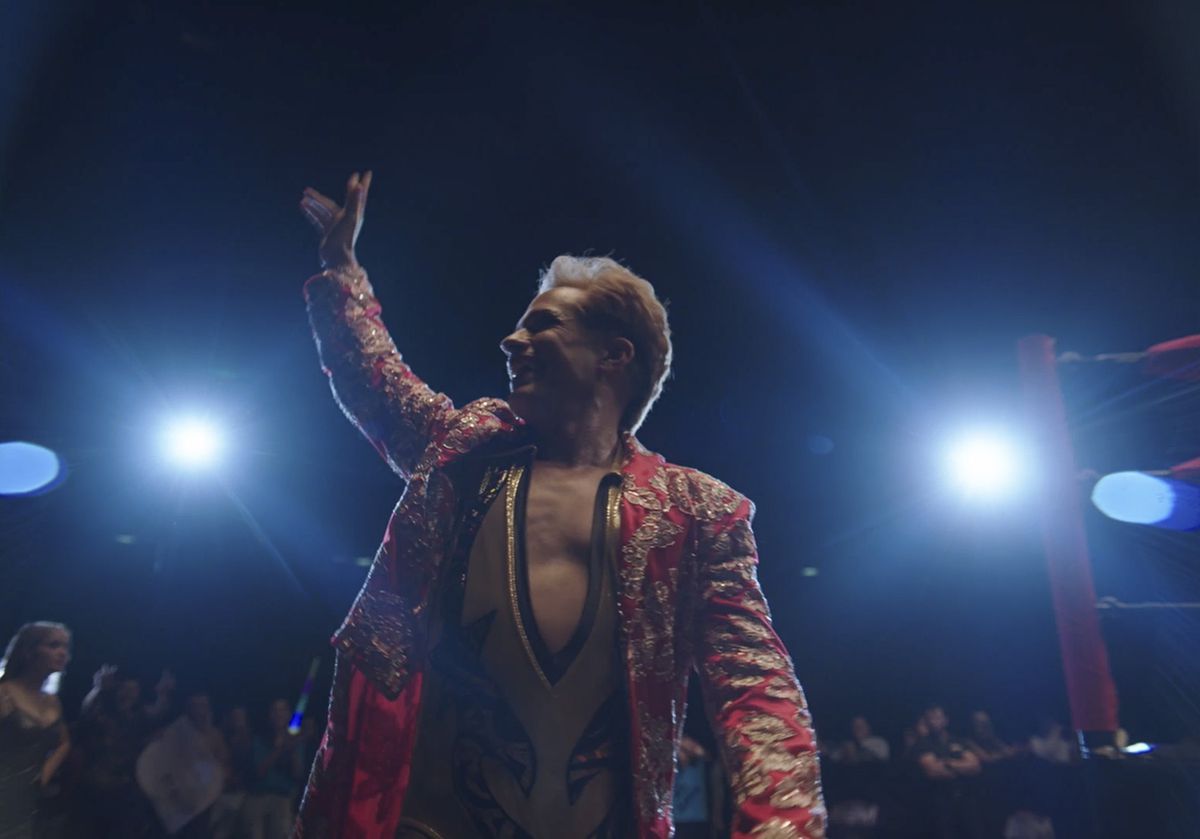 Gael García Bernal waves to the crowd in an extravagant wrestling outfit as Cassandro.