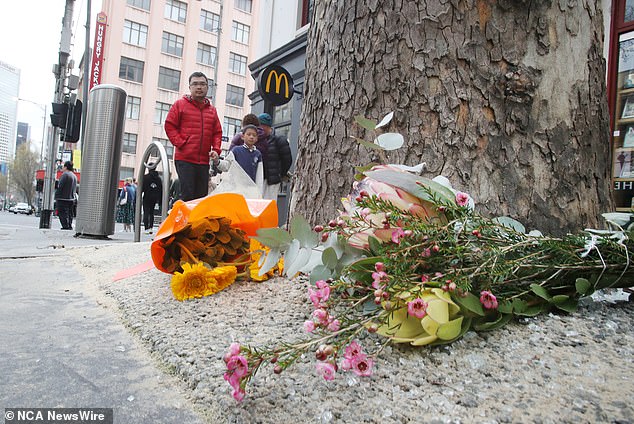 Bunches of flowers have been left at the corner of Bourke Street and Russell Street in Melbourne CBD where Ms Haasz, a grandfather and noted philanthropist, died