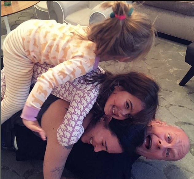 Doting Dad: Bruce pictured with three of his daughters, including the two he shares with Emma