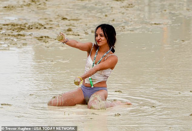 Chicago's Shai Peza frolicking in the mud and water at Burning Man on Saturday