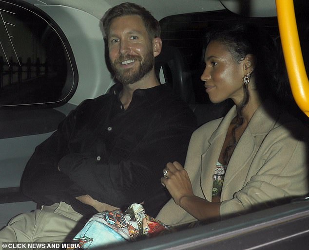 Home time: The engaged couple got comfortable as they headed home in a taxi