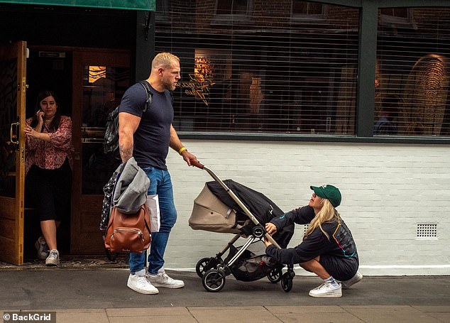 Keeping it casual: The fitness trainer wore an oversized gray sweatshirt with the word 