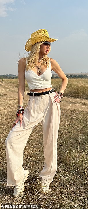 Strike a pose: The model wore white wide-leg pants that she paired with a sleeveless white crop top with a plunging neckline