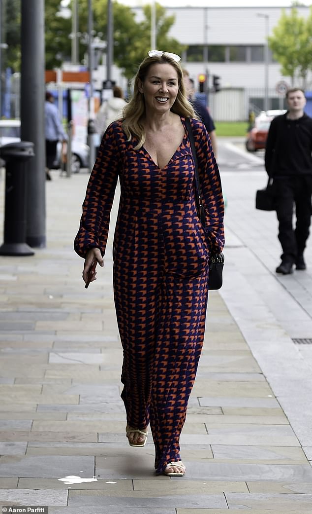 Gorgeous: Claire Sweeney, 52, looked as chic as ever in a chevron print jumpsuit as she enjoyed a break from filming in Manchester on Wednesday