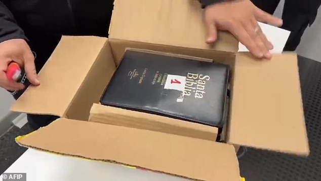 An agent from Argentina's Directorate General of Customs opened a box containing three Bibles used to hide $16,800 being shipped to the United States