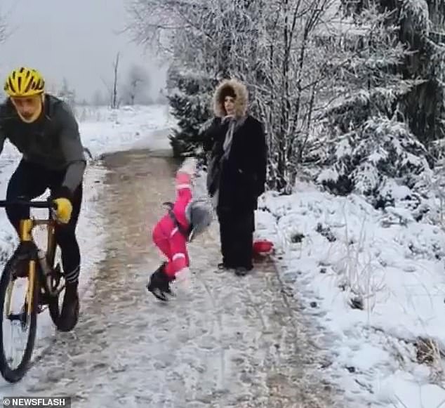 A Belgian cyclist (left) who went viral after he was filmed kneeling a little girl and knocking her to the ground as he rode past her and her family has won a lawsuit against her father for posting the images online