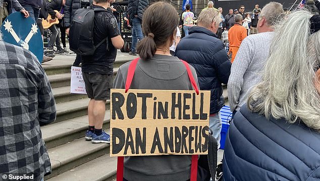 One protester (pictured) expressed the wish that Daniel Andrews would 'rot in hell'