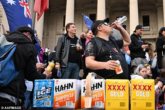 Hundreds of people (pictured) have gathered on the steps of the Victorian Parliament to celebrate the resignation of Premier Daniel Andrews