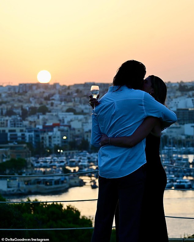 The singer shared the news on Instagram on Thursday evening, along with a loved-up photo of the couple on holiday in Malta.  The image shows Delta tenderly embracing Matthew in front of a beautiful sea view as the sun sets in the foreground