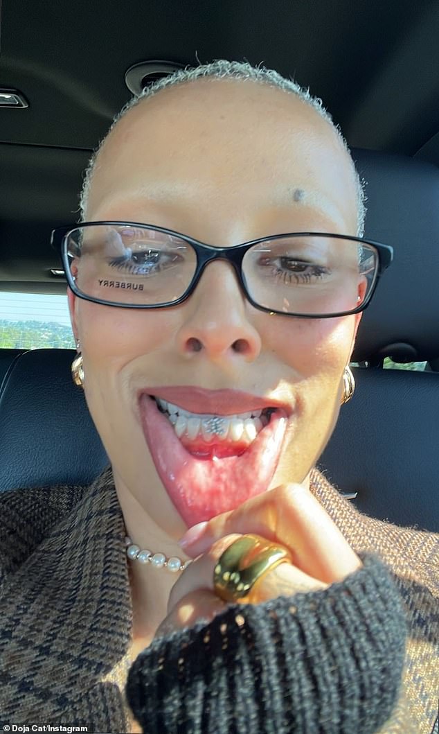 Teeth bling!  Problematic pop star Doja Cat has spent the past two years transforming her pop polish into dark and edgy, and on Monday she showed off her latest favorite accessory: the diamond grill.