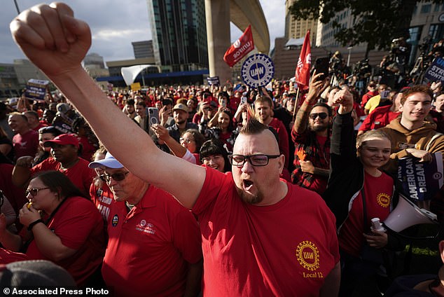 United Auto Workers member Brian Rooster Heppner raises his fist as he cheers during a rally in Detroit on Friday