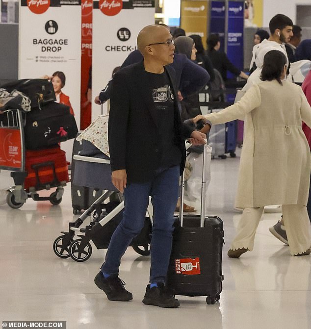 The embattled neurosurgeon, 65, was spotted checking into his Qatar Airways flight to Doha at Sydney International Airport on Tuesday night