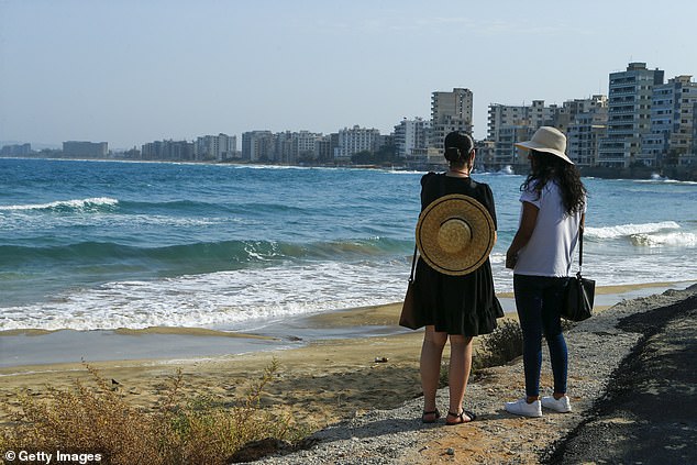 Tourists stand on a newly opened beach in Famagusta, Cyprus on October 9, 2020 (file image)