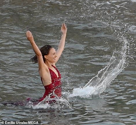 Beaming: She happily splashed around in the water